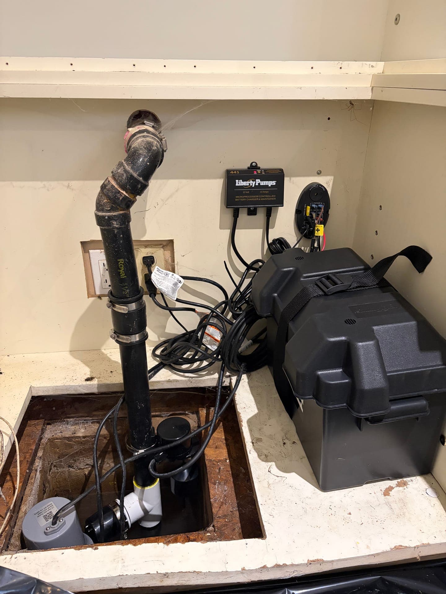Sump pump installed with a battery backup system in a Milton basement